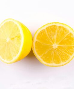 Close-up of fresh, juicy lemon halves on a clean white background.