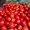 Fresh red tomatoes piled up at a local market, perfect for healthy recipes.
