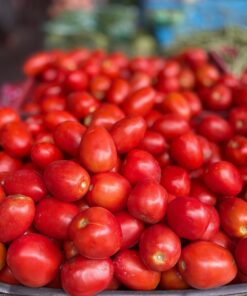 Fresh red tomatoes piled up at a local market, perfect for healthy recipes.