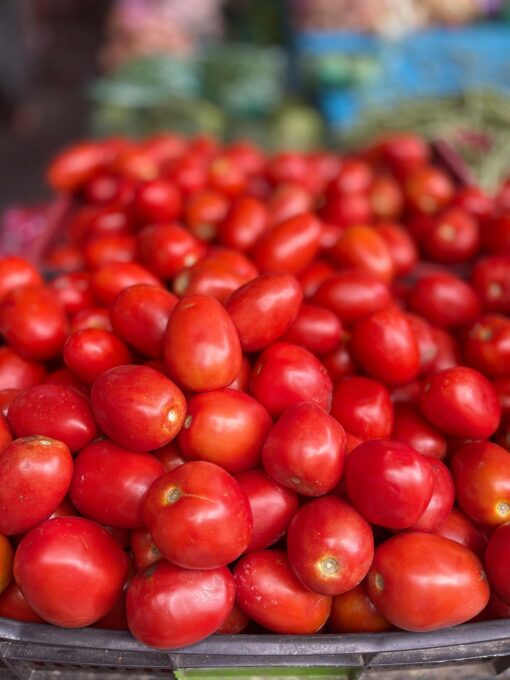 Fresh red tomatoes piled up at a local market, perfect for healthy recipes.